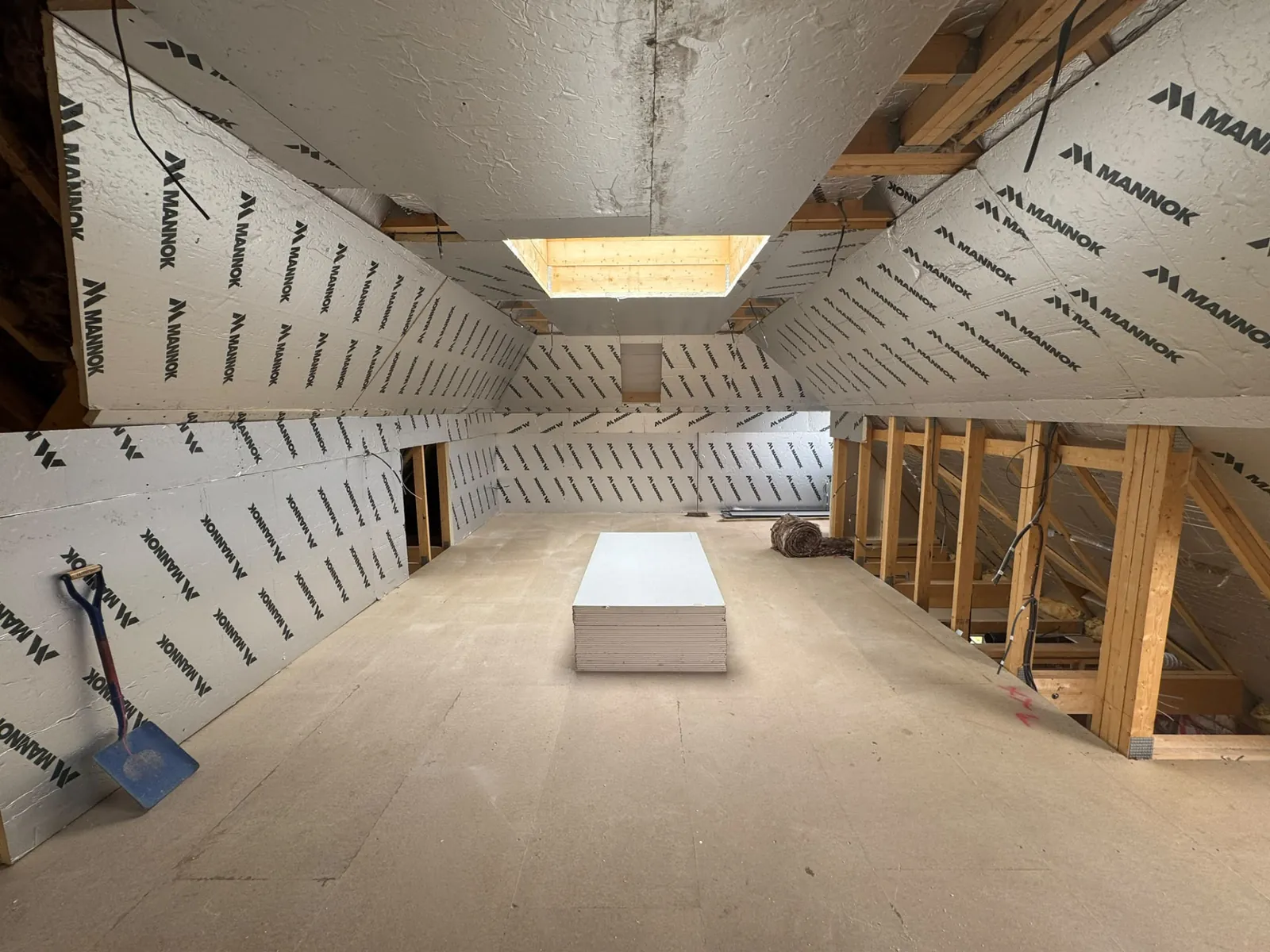 Insulated loft conversion with roof light opening before plastering