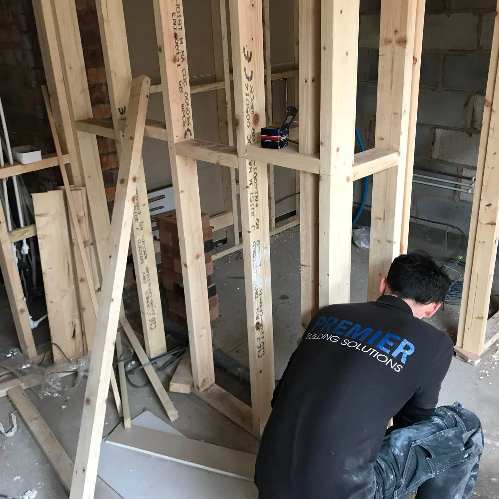Premier Building Solutions builder constructing timber stud walls during a renovation