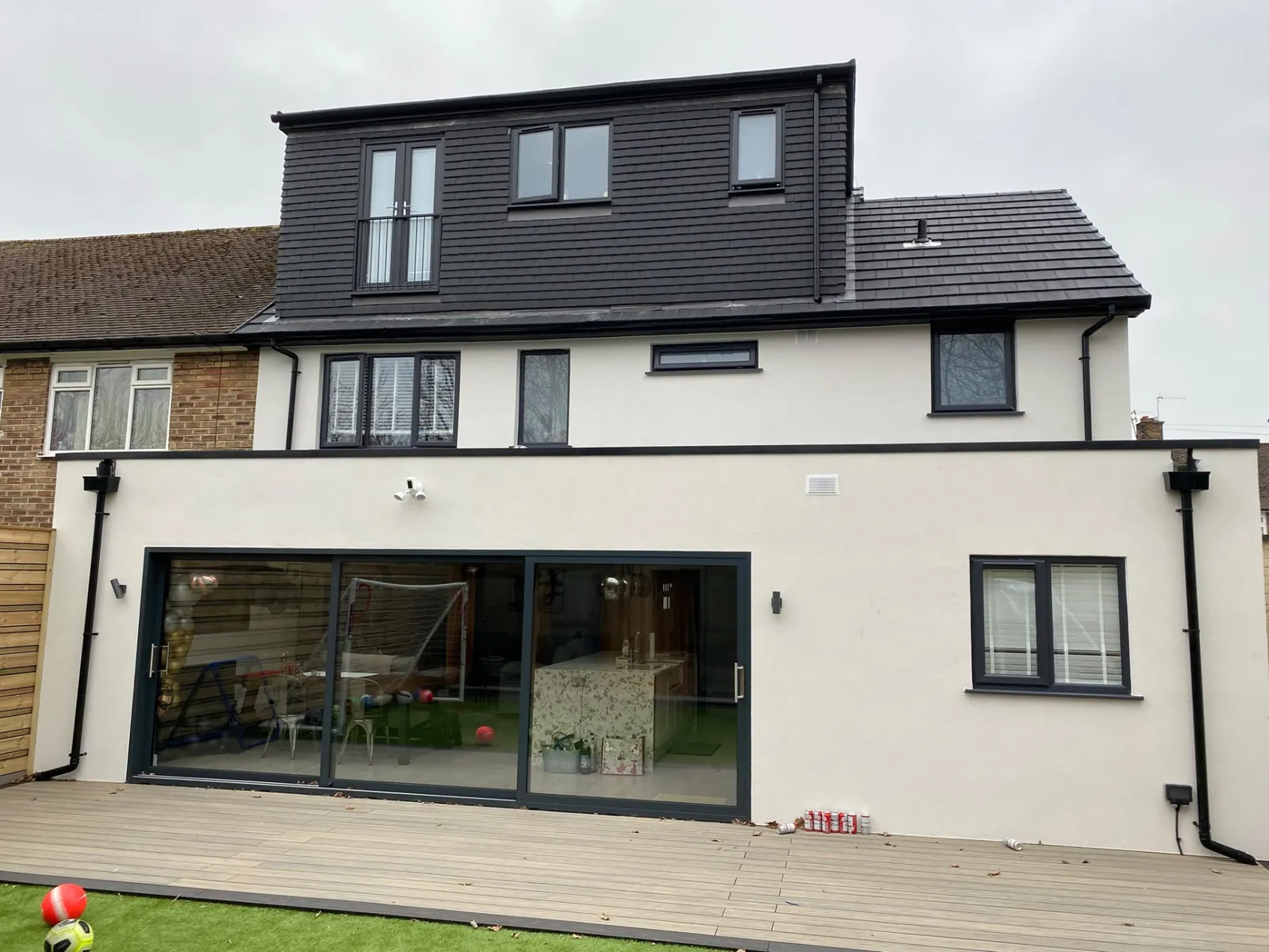 Completed dormer loft conversion with Juliet balcony above a rendered rear extension