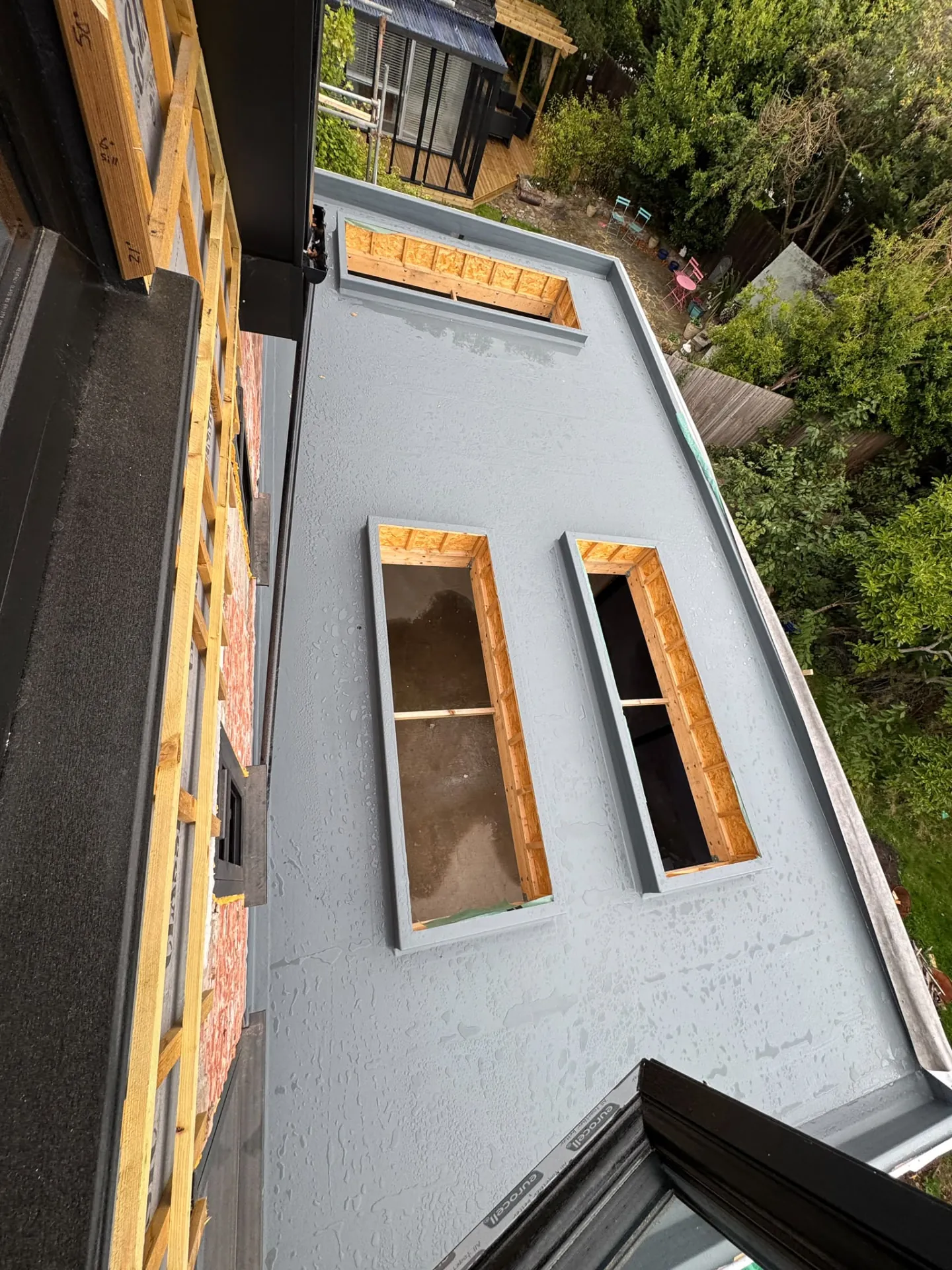 Extension roof framing with openings for roof lights