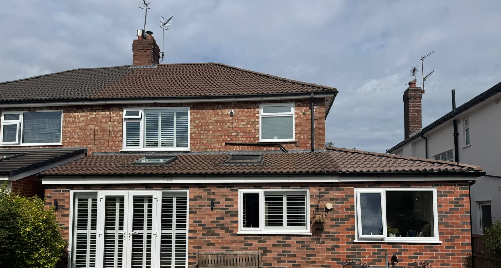 Single-storey brick rear extension with French doors, roof lights and a stone patio