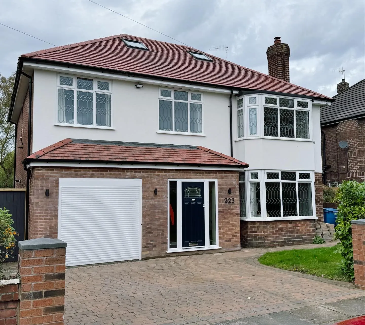 Finished two-storey house extension in brick and render with driveway