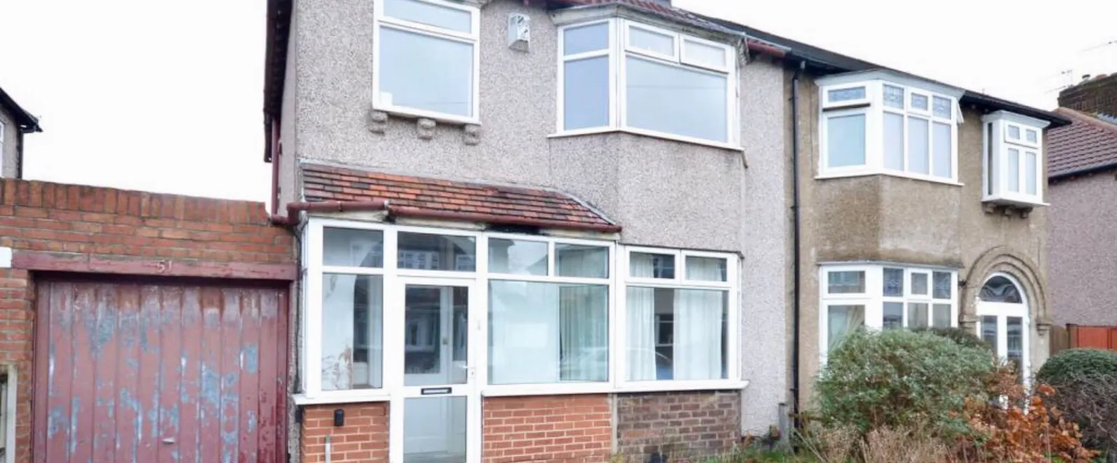 Before: the same house with pebbledash and the old porch and garage