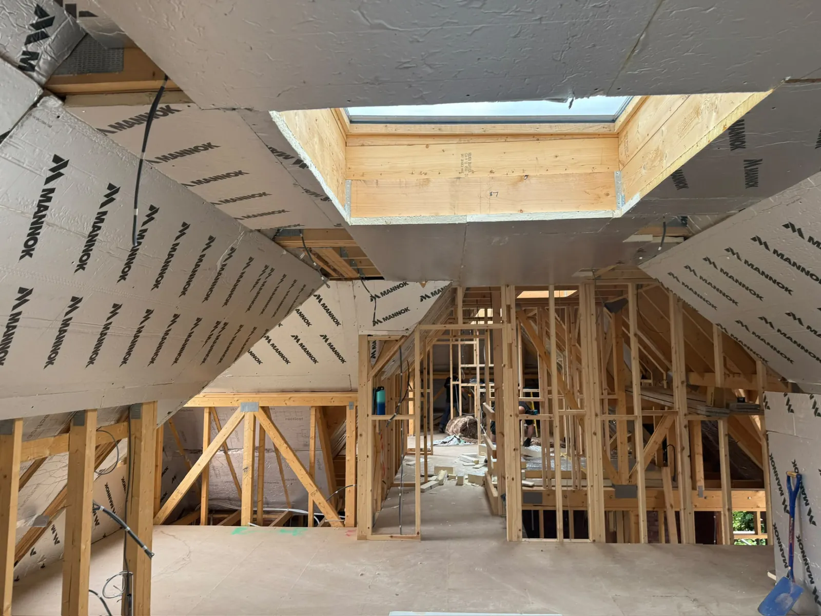 Loft conversion with insulation boards, roof light and new stud walls