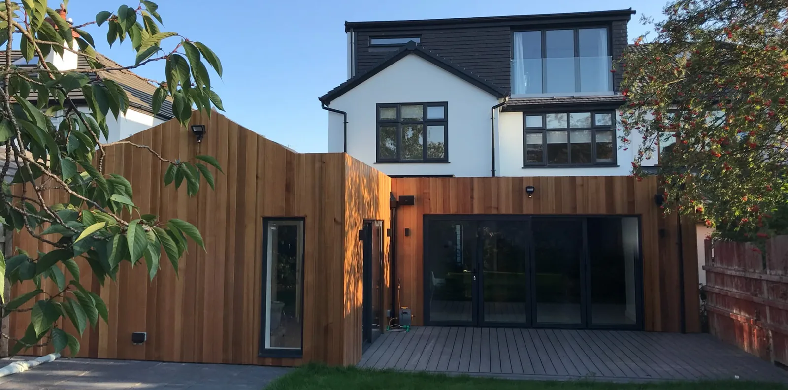 After: timber-clad rear extension with a dormer loft conversion above